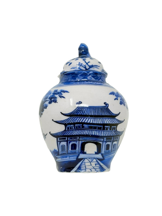 a blue and white vase with a painting on it