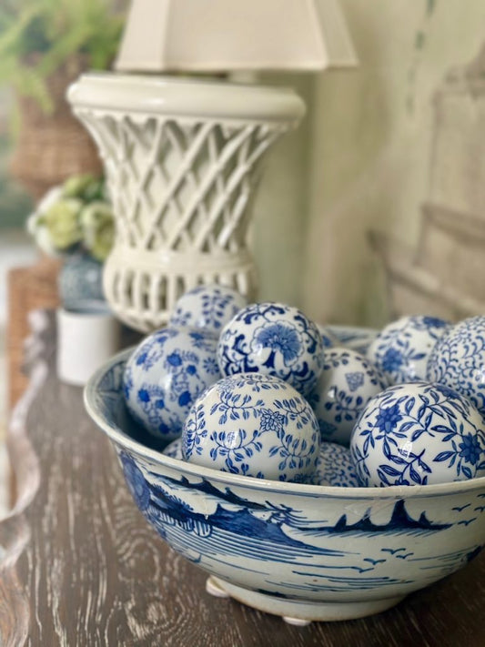 a bowl of blue and white painted balls