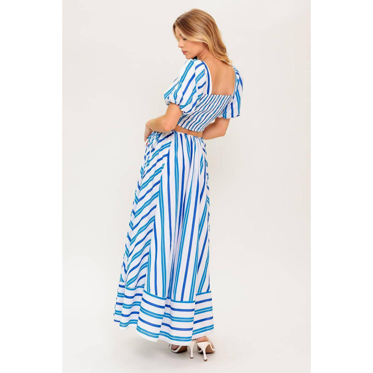 a woman in a blue and white striped dress
