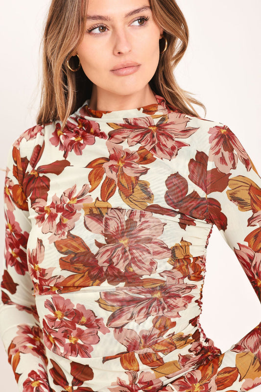 a woman wearing a floral shirt
