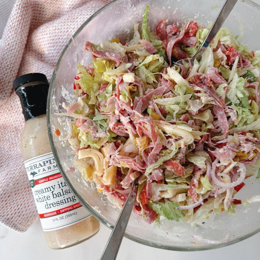 a bowl of salad with fork and knife
