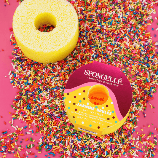 a sponge and sprinkles on a pink surface