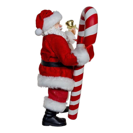 a santa holding a large candy cane