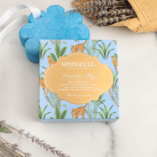 a box with a blue design next to a blue sponge and lavender