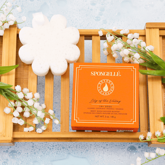 a wooden tray with flowers and sponges on it