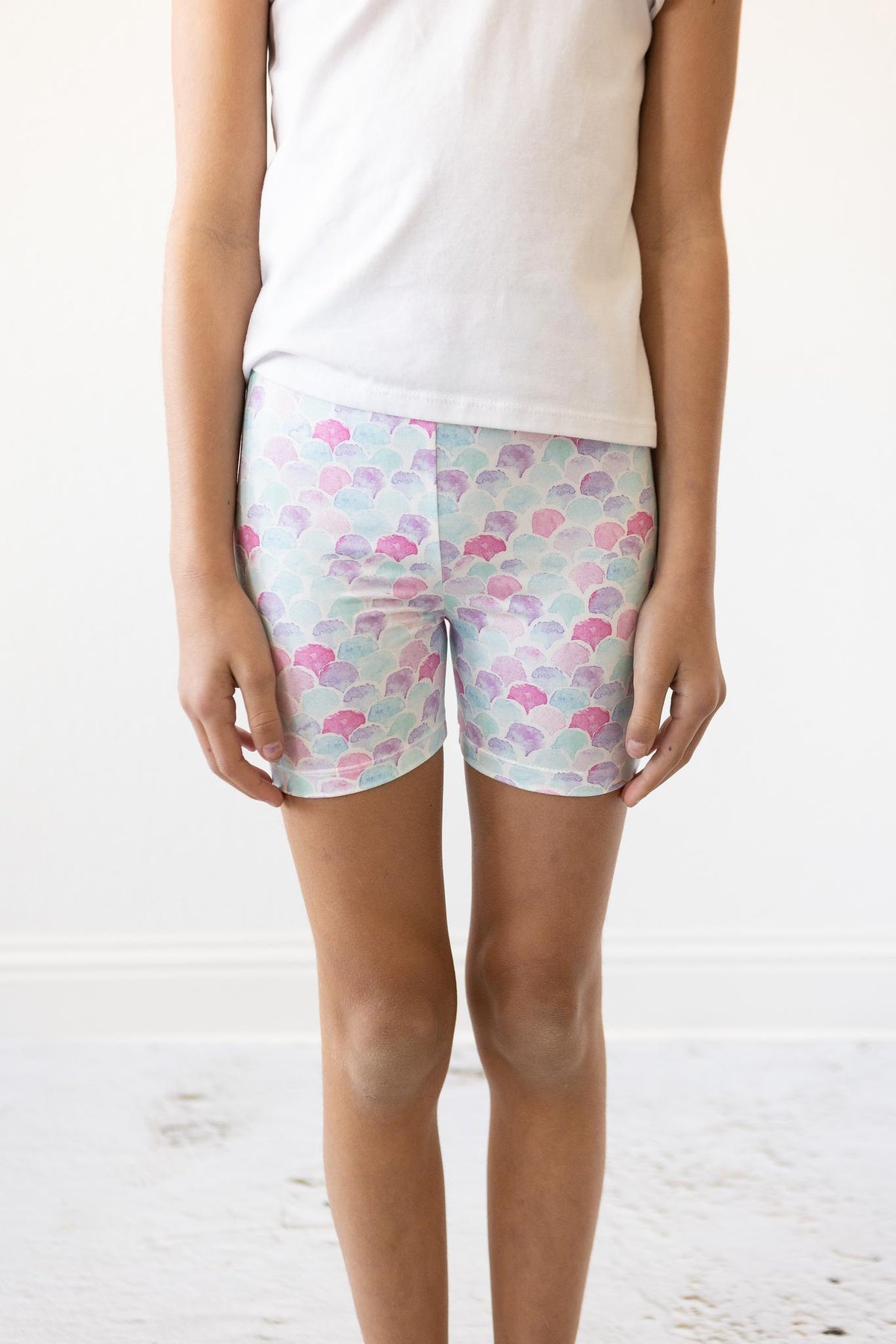 a person wearing shorts and a white shirt