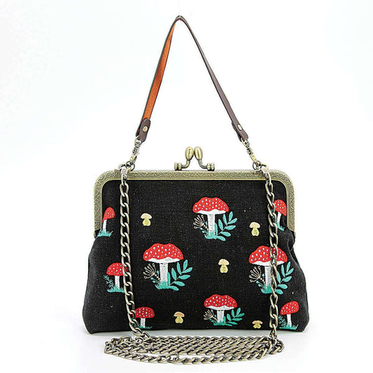 a black purse with mushrooms on it