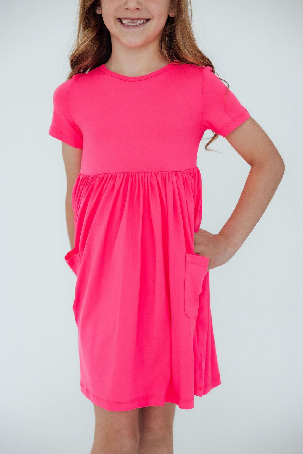 a girl in a pink dress