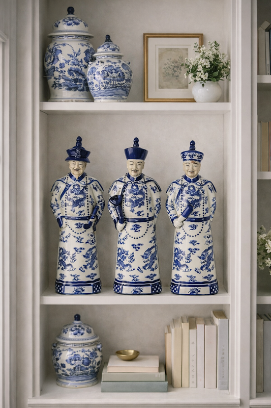 a white and blue china statues on a shelf