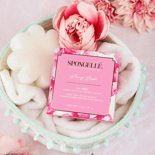 a pink flower and a box of soap in a bowl