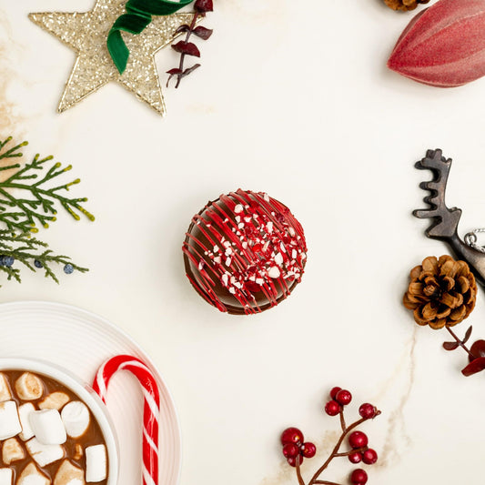 a cup of hot chocolate and candy canes