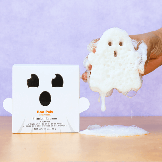 a hand holding a white object with a ghost shaped object in it