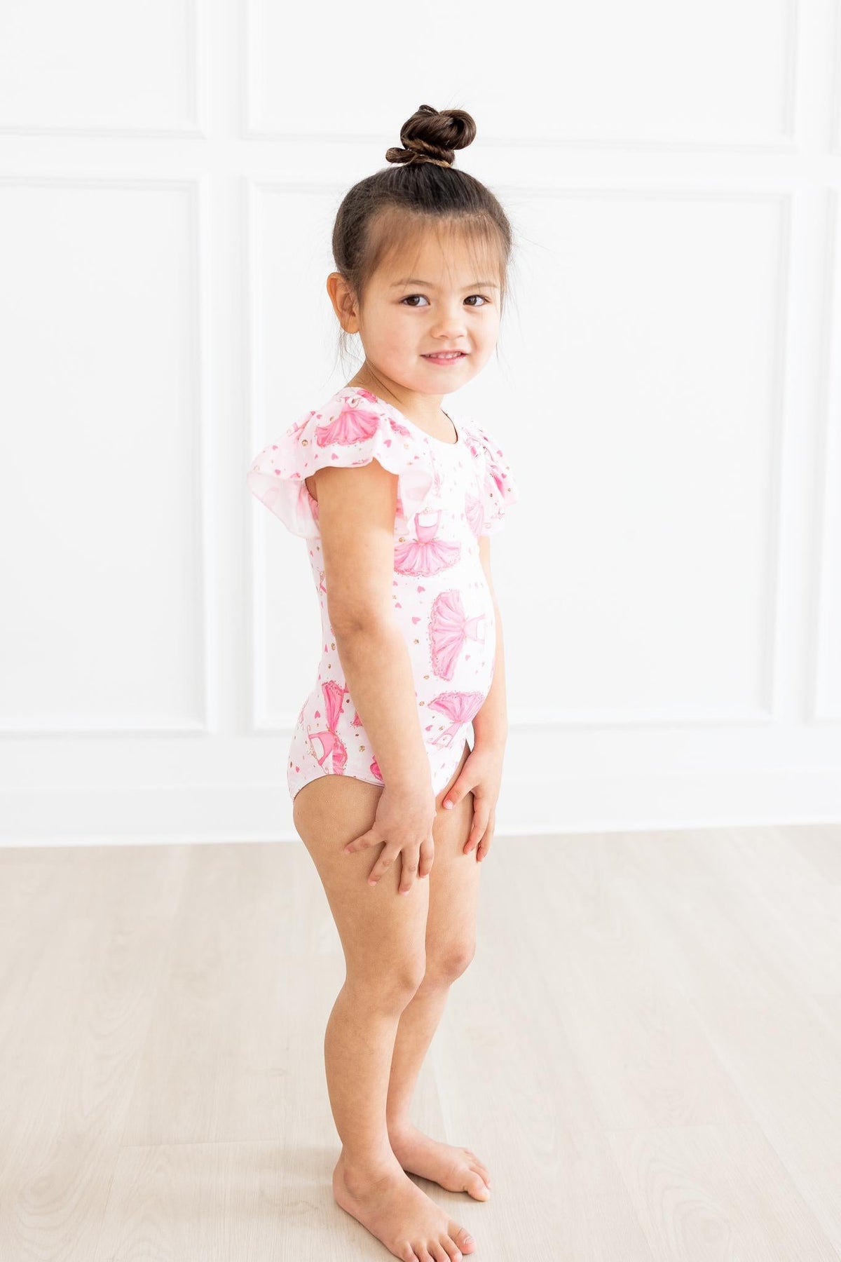 a girl in a pink leotard