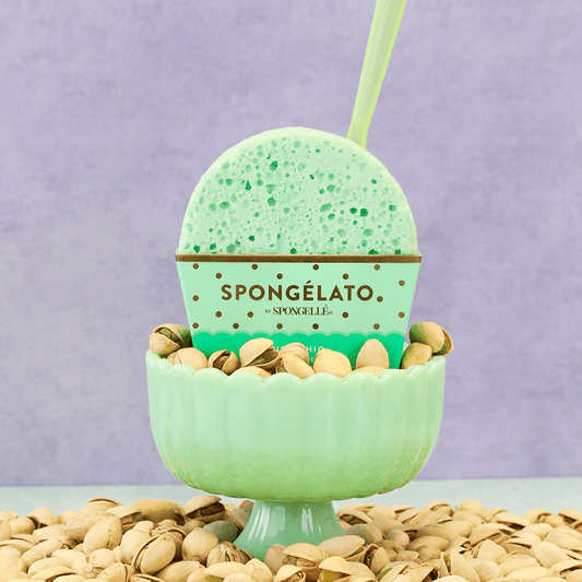 a green dish with a spoon in it