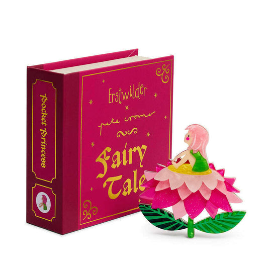 a pink book with a toy on it