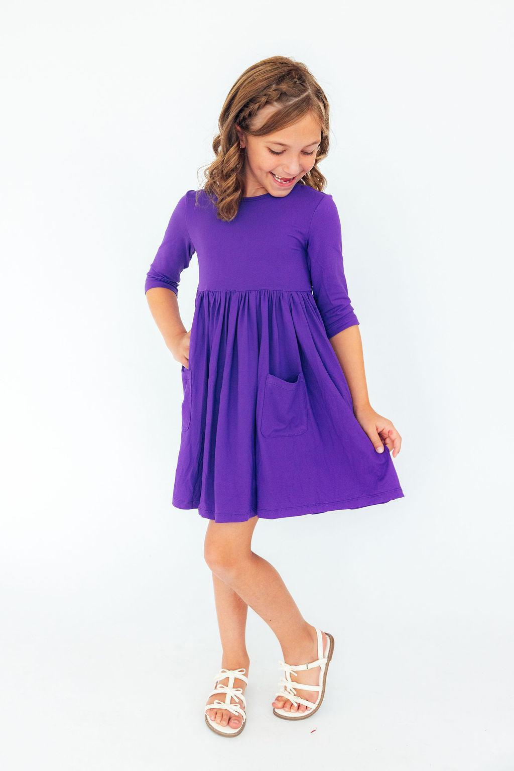 a girl in a purple dress