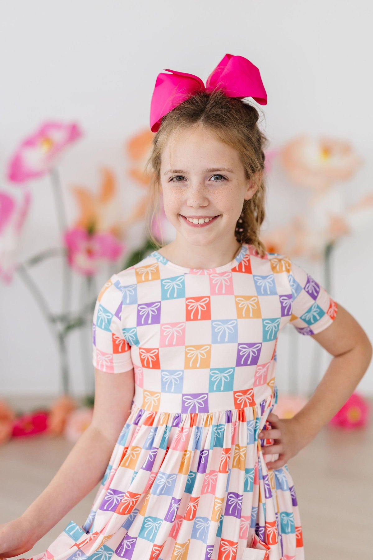 a girl with a pink bow on her head