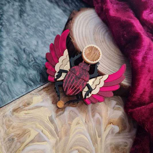 a wooden beetle with wings on a piece of wood