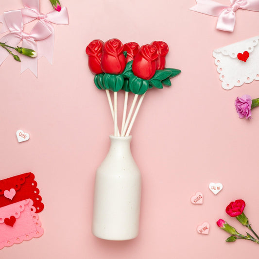 a vase with flowers and envelopes