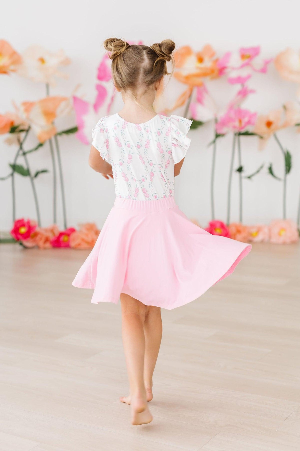 a girl in a pink skirt