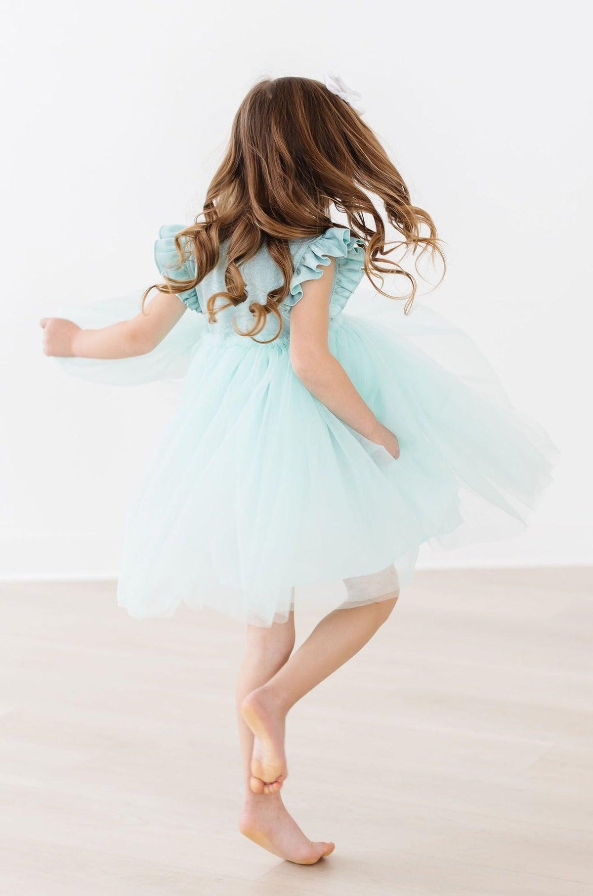 a girl in a dress dancing