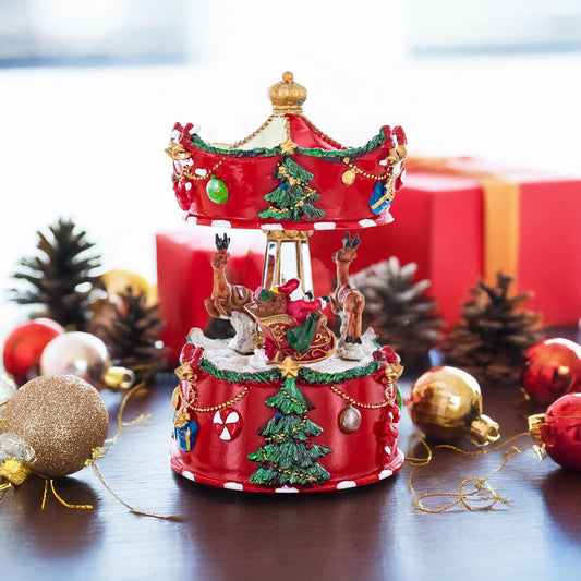 a red carousel with ornaments and a box with a bow
