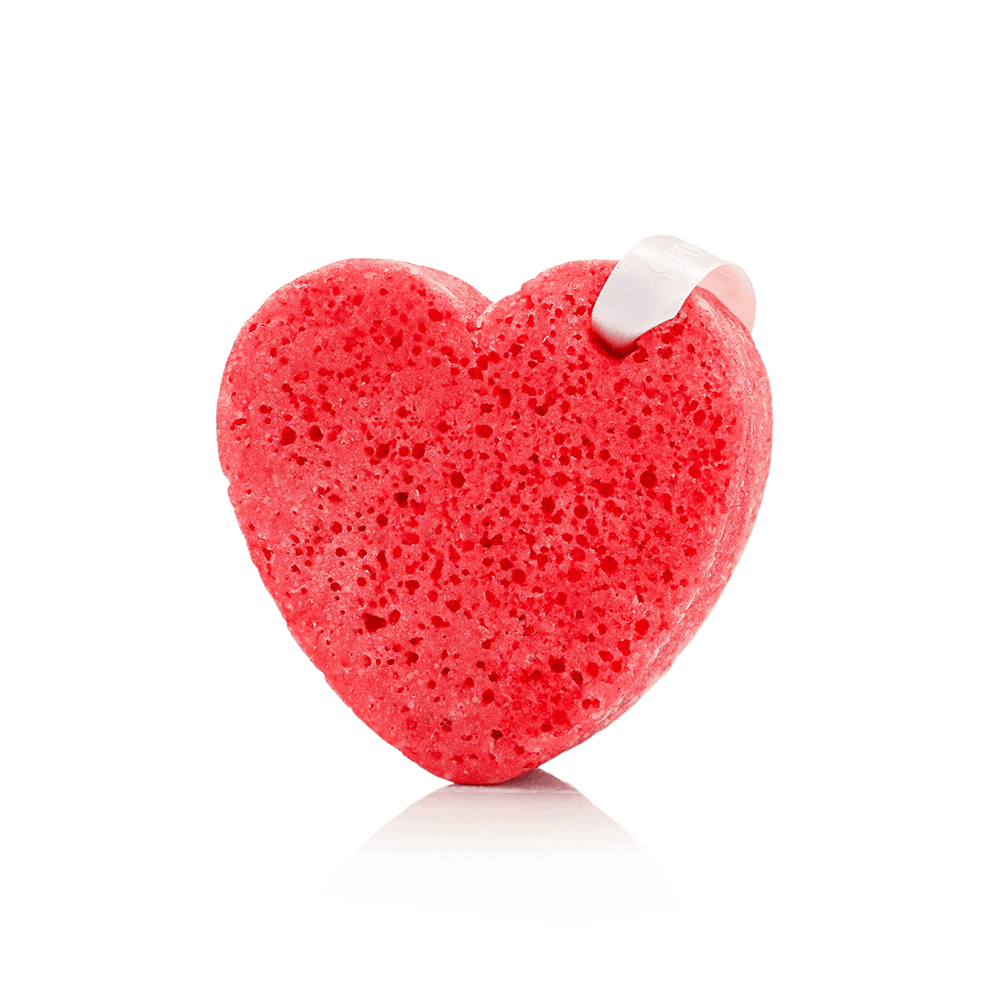 a red heart shaped sponge with a white tape
