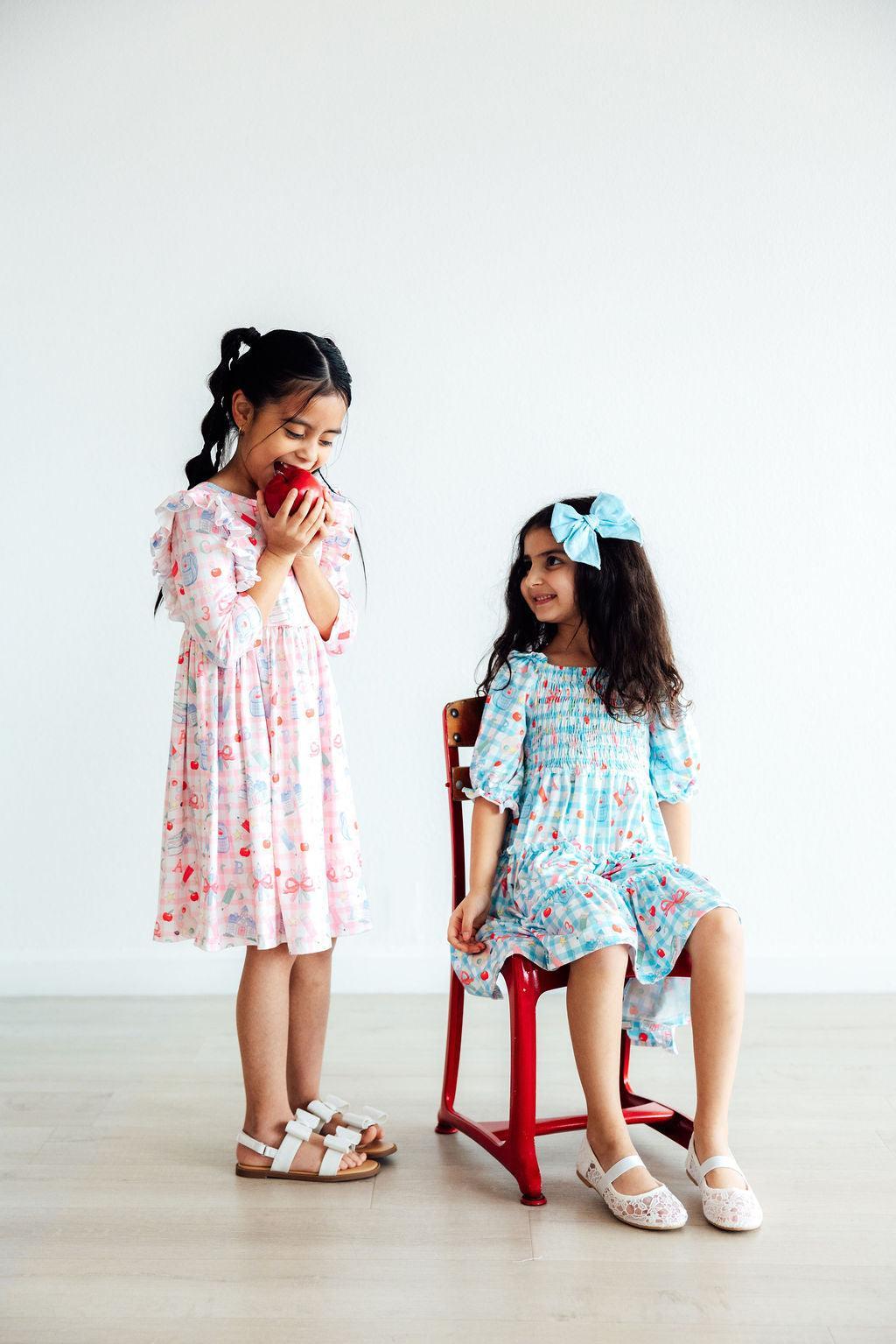 two girls sitting on a chair