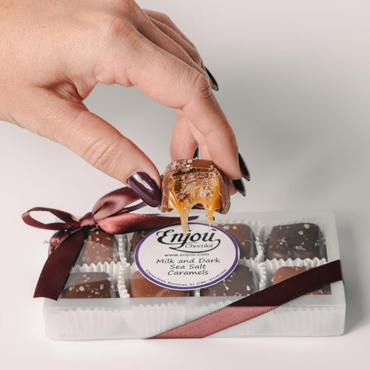 a hand holding a caramel candy