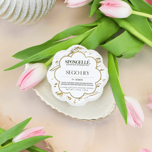 a pink tulips and a round white object on a gold plate