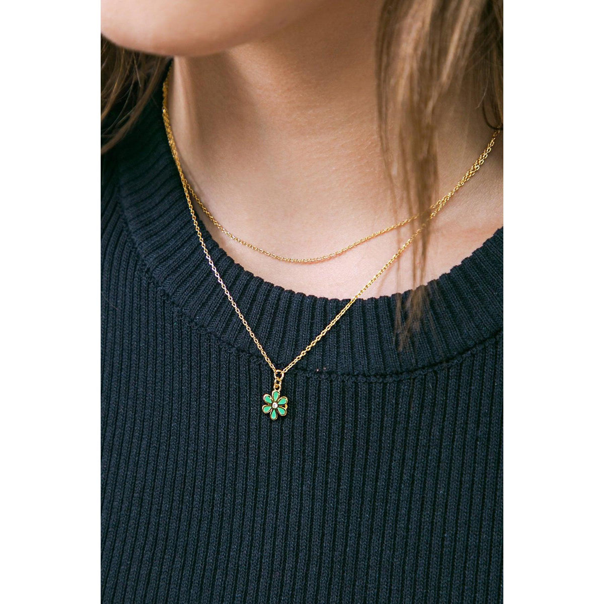 a woman wearing a necklace