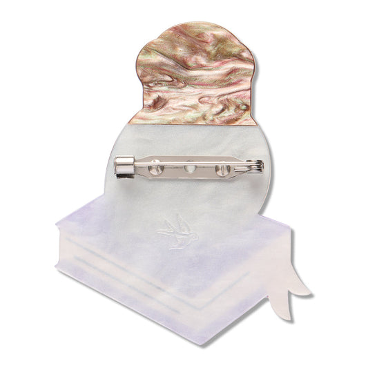 a brooch with a piece of paper