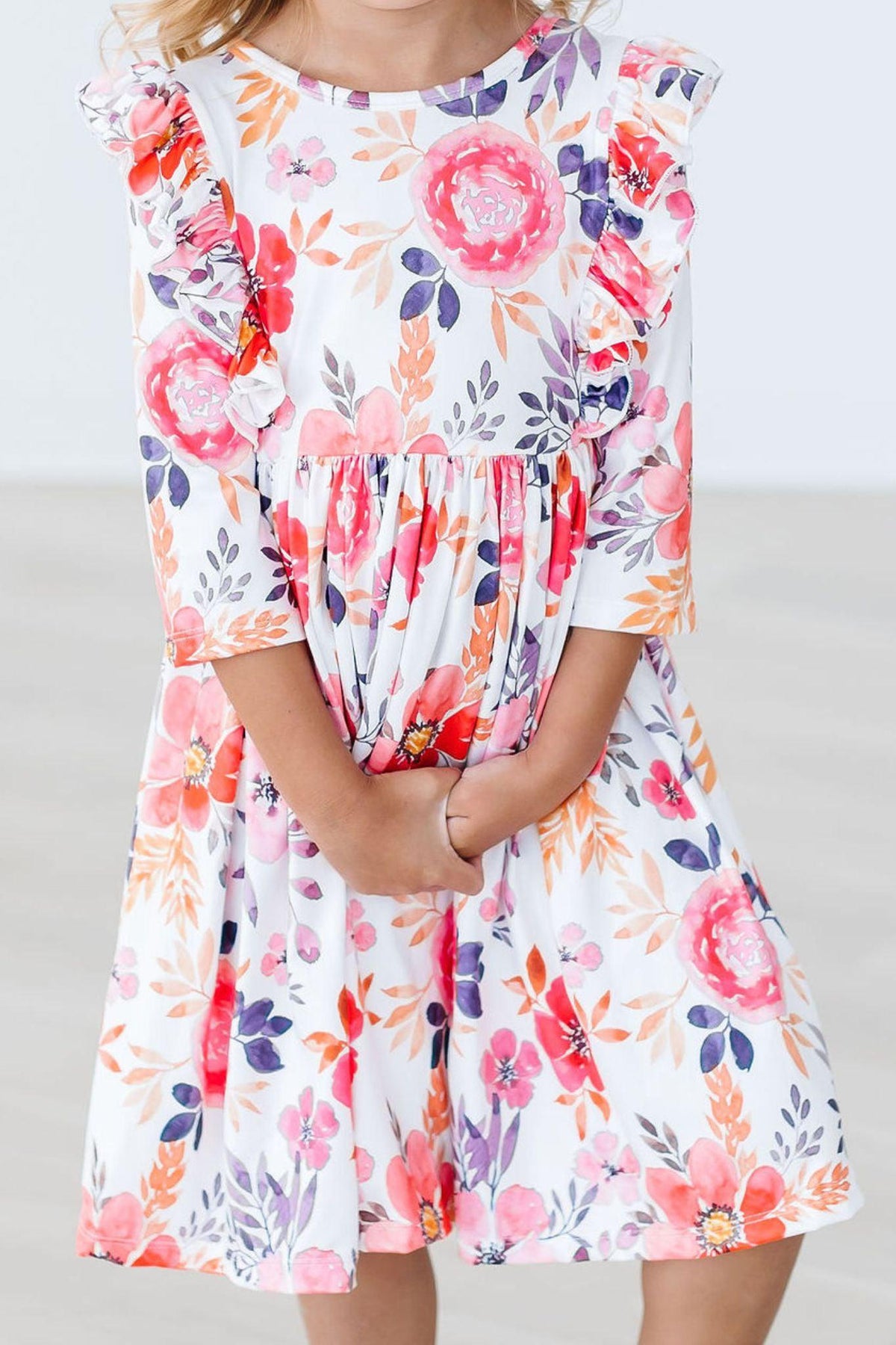 a girl wearing a dress with flowers