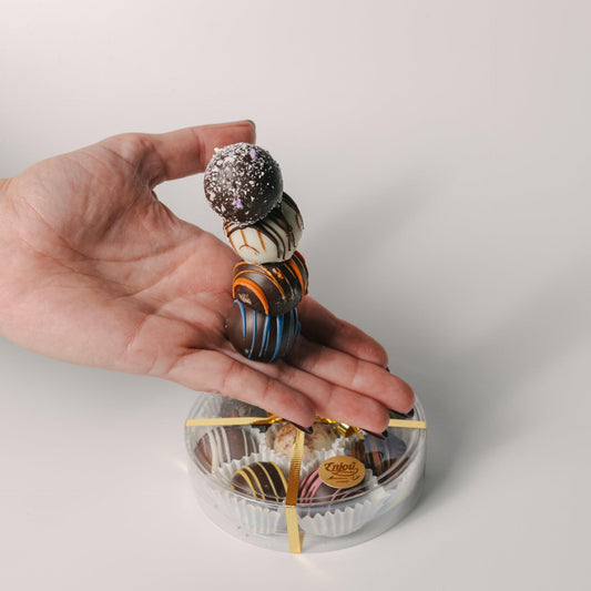 a hand holding a stack of chocolates