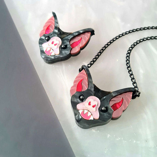 a pair of necklaces with a bat face