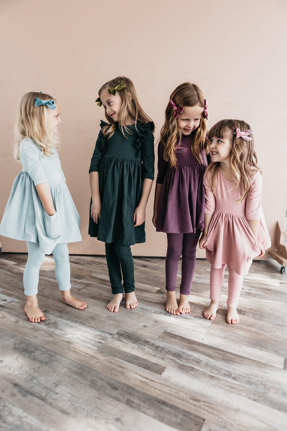 a group of girls in dresses