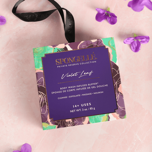 a purple box with a black ribbon and purple flowers