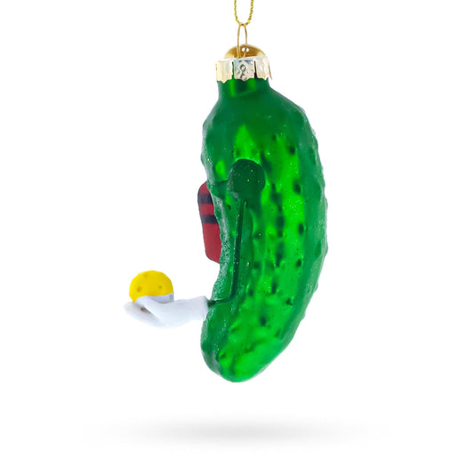 a green pickle ornament with a yellow ball