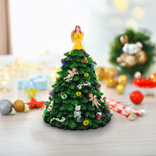 a small christmas tree with a small angel on top
