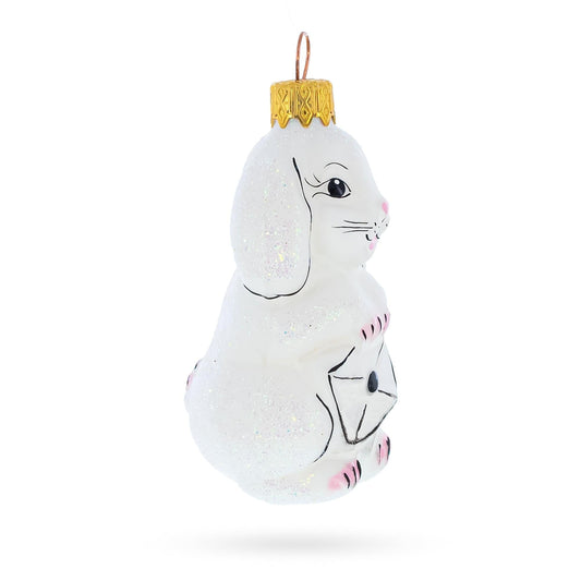 a white bunny ornament with a gold top