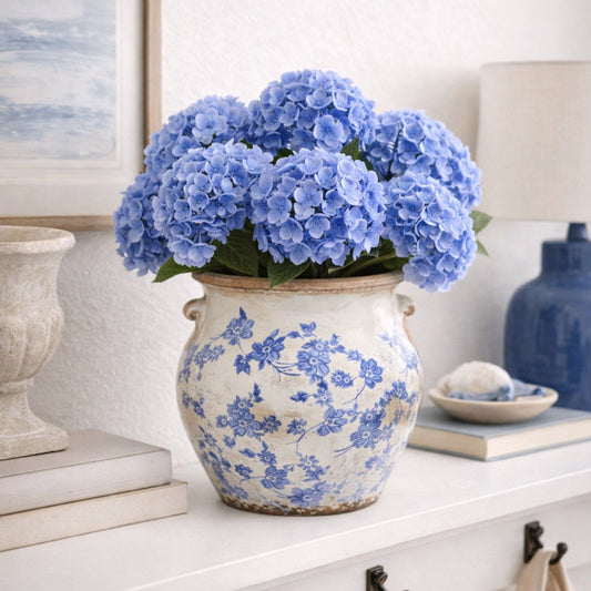 a vase with blue flowers