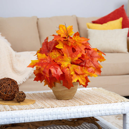 a vase with orange leaves on a table