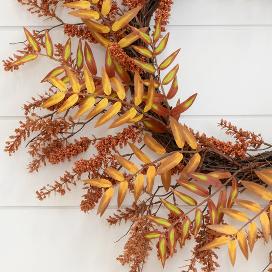 a wreath with orange leaves