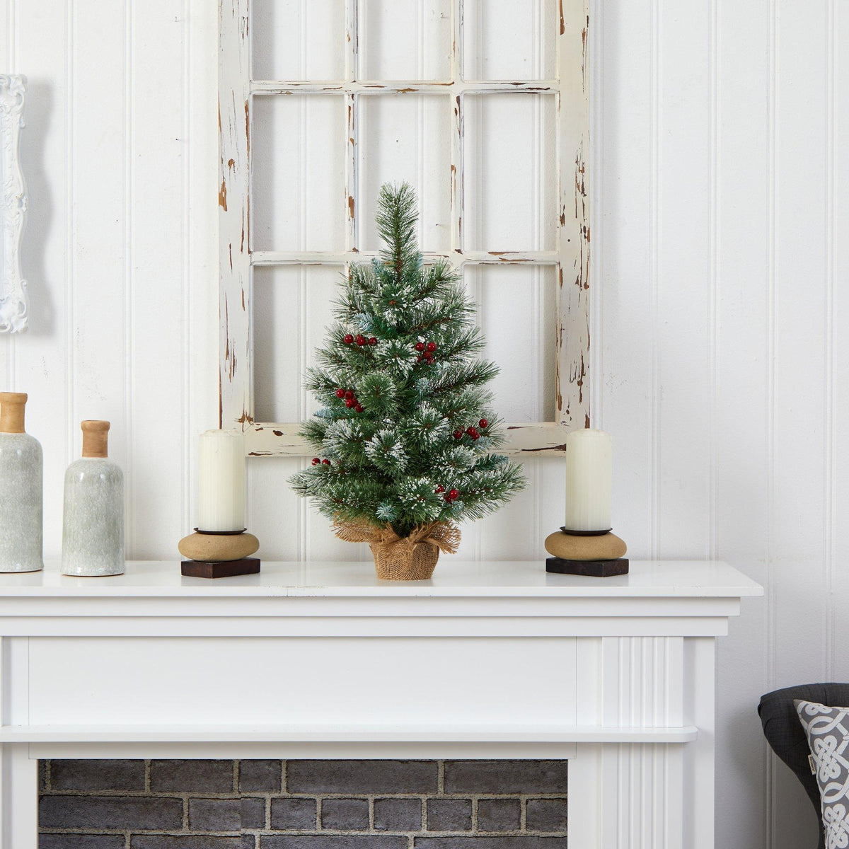 a small christmas tree on a white mantle