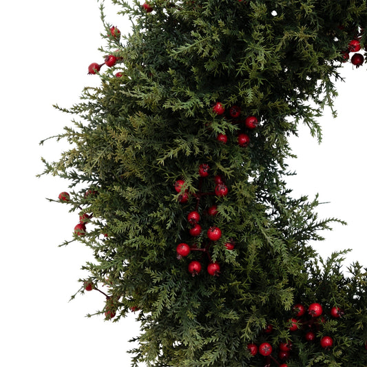 a wreath of green leaves with red berries
