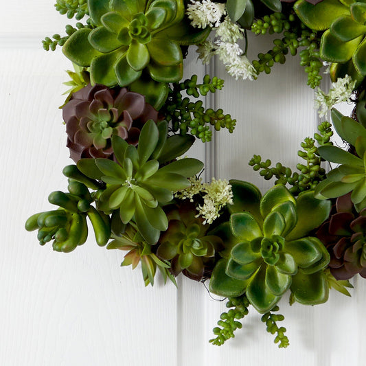 a wreath of succulents on a white door