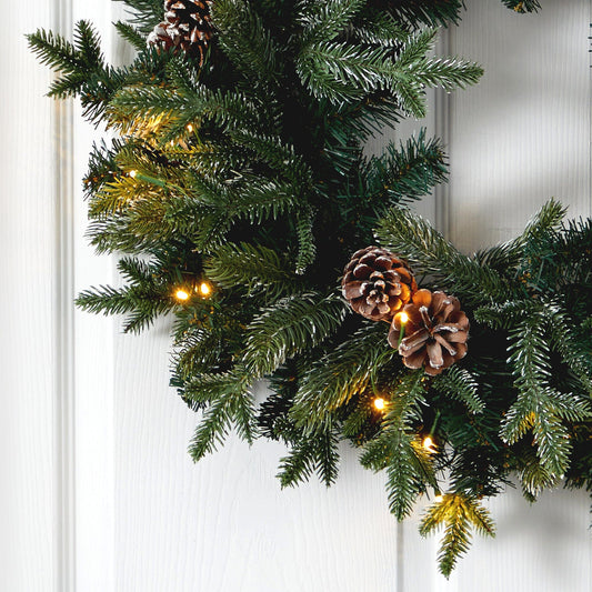 a wreath with lights and pine cones