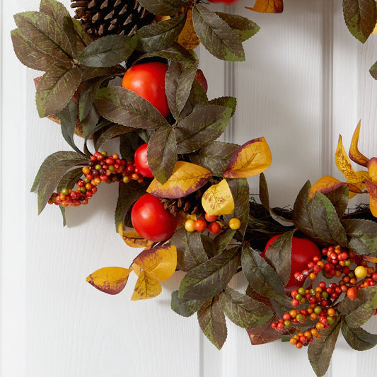 a wreath with leaves and fruits