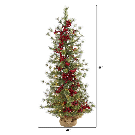 a tall christmas tree with red berries and lights