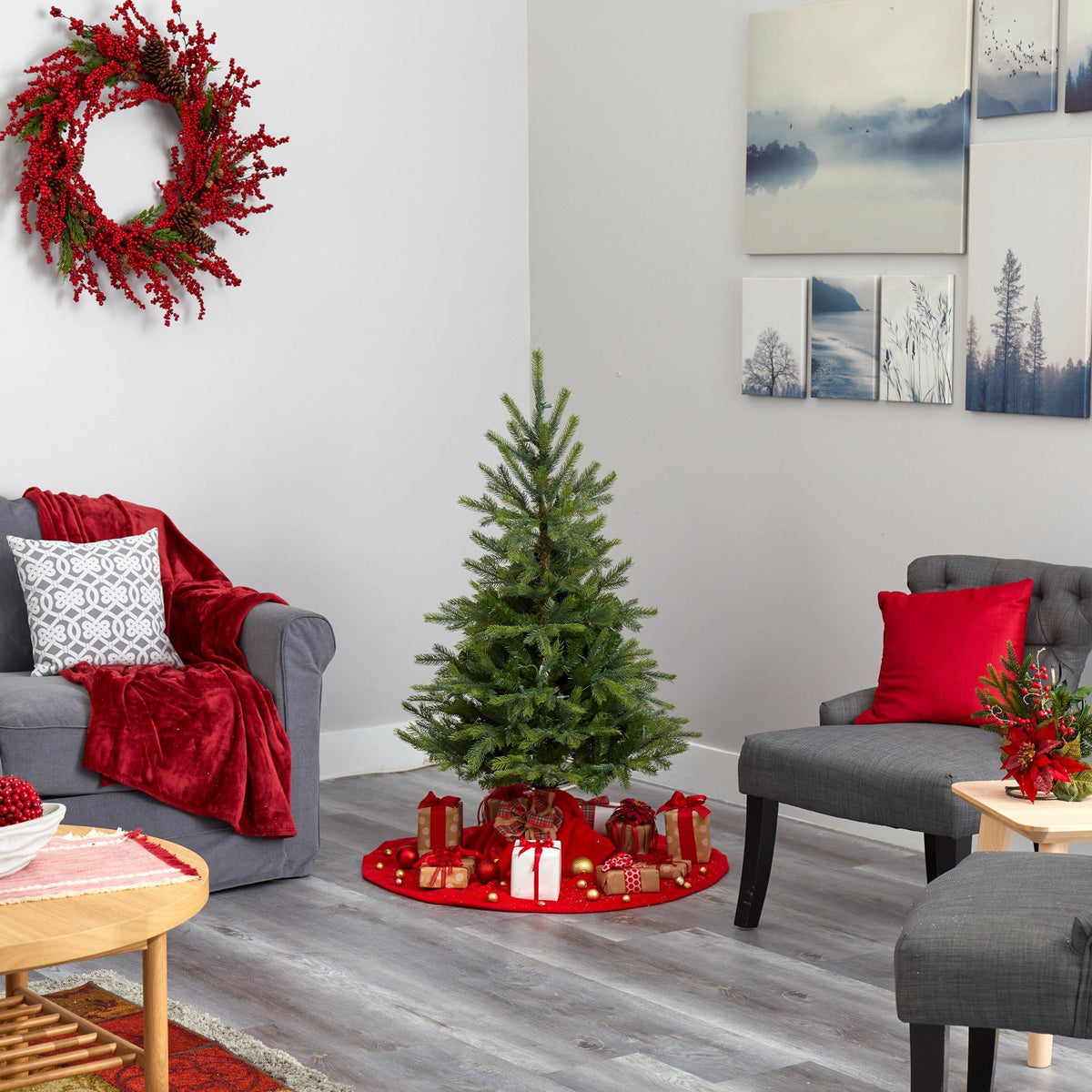 a living room with a christmas tree and a wreath